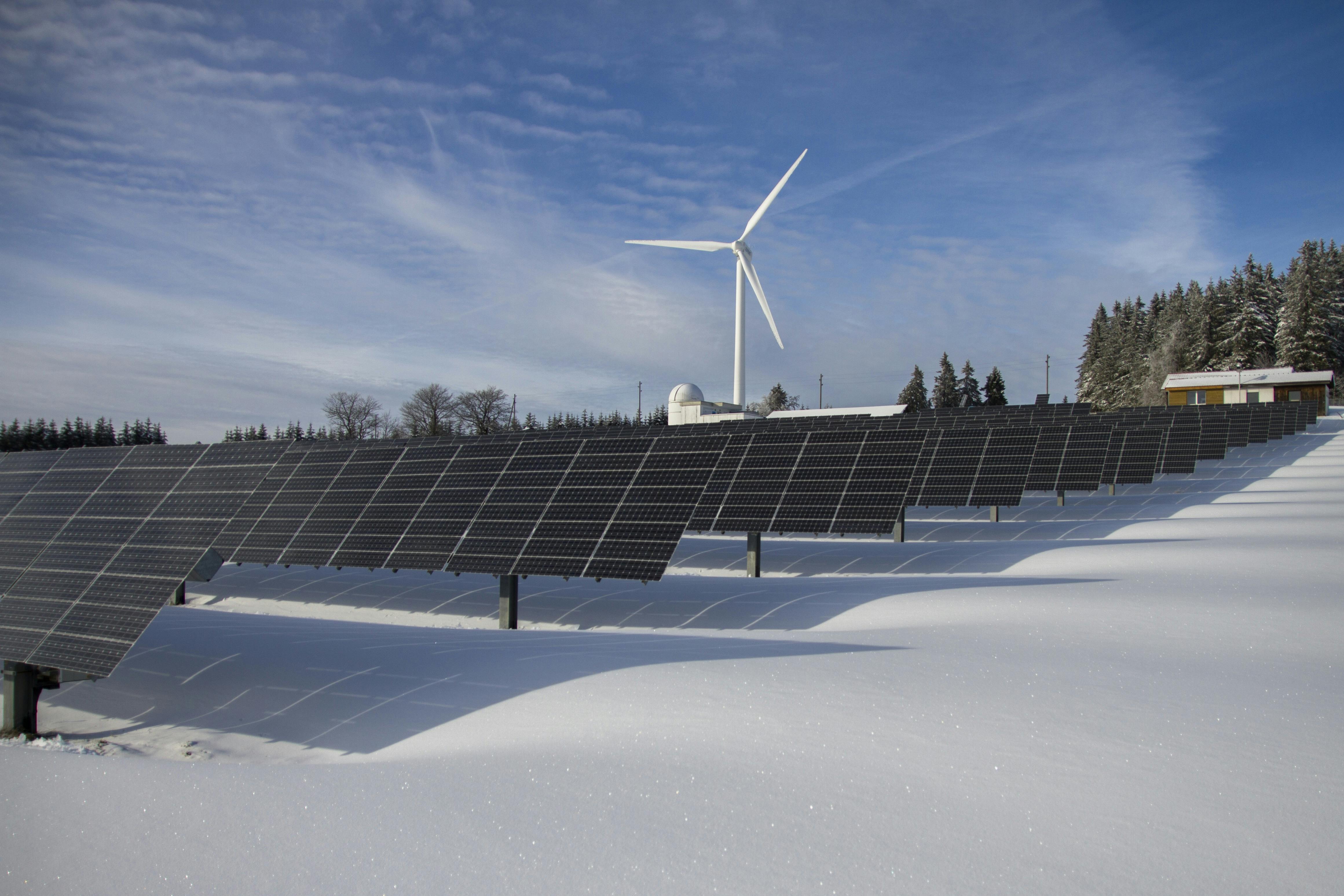 Solar panels and wind turbine in snow - Sustainable Procurement